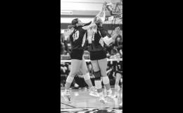 Minneota’s Leah Coequyt, left, and Jaylyn Coequyt team up to block an attack by Lac qui Parle Valley last Tuesday in Minneota. 