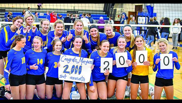 Photo for the Mascot by Brian Jeremiason Morgan Kockelman (holding the poster) and her teammates celebrated the Camden Conference Championship and Kockelman's, 2000 assists.