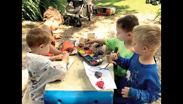 Special photo. A pile of the painted rocks are gathered (above). Meanwhile, Hudson Hjetmstad and Dylan Remme (left) and Liam Hennen and Titan Fier paint rocks.