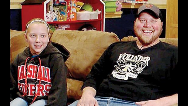 Photo courtesy WCCO-TV. Skyla and her dad Andy Crowley during the filming at their home.