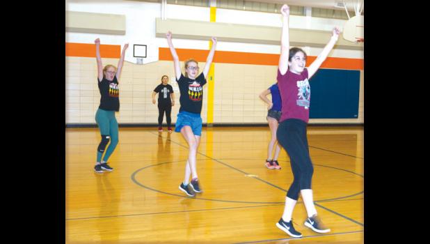Photo for the Mascot by Sue Jacobson. Anna Gruenes flashed a smile as her arms went up into the air.