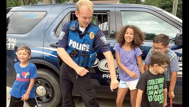 Special photo. At a local daycare, Austin Thompson stopped to enjoy showing off some "moves" with the kids.