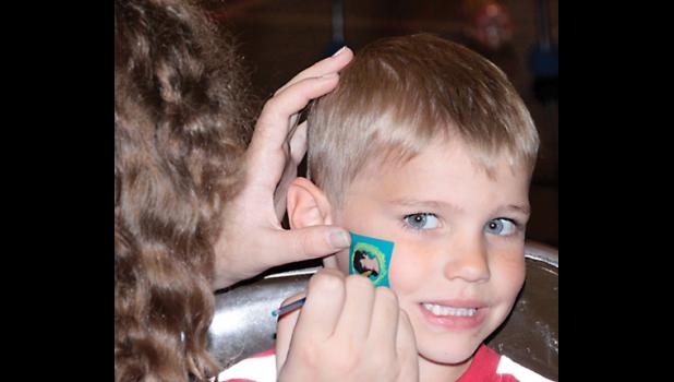 Staff Photo by Byron Higgin. Getting his face painted was Mason DeSmet.