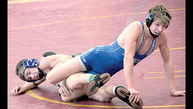 Staff Photo by Byron Higgin. Minneota’s Brant Buysse at 126 pounds and Z-M’s Mike Vath seemed to be all tangled up. Vath won, 4-2.