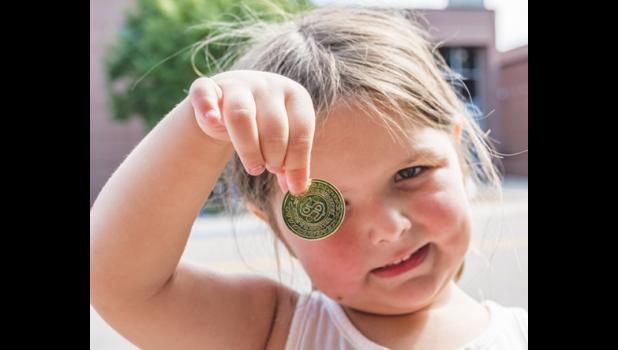Photo for the Mascot by Brian Jeremiason. Lydia Skorczewski shows off the coin she received from Captain Jack Sparrow during the parade on Sunday.