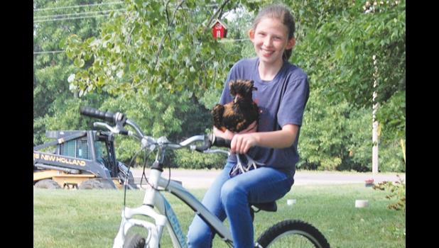 Mascot photo by Scott Thoma Kelly also enjoys taking her hens from a bike ride.