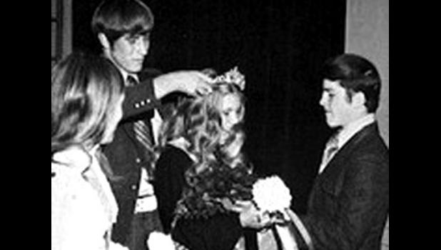 Special photo. Jeff Seifert places the crown on Cindy (Wigness) Hawkins while Tom Walsh looks on during the coronation ceremony in 1972.