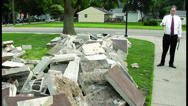 Staff Photo by Byron Higgin. Supt. Dan Deitte showed piles of concrete outside the elementary building during a school board tour of the work in progress at the school.