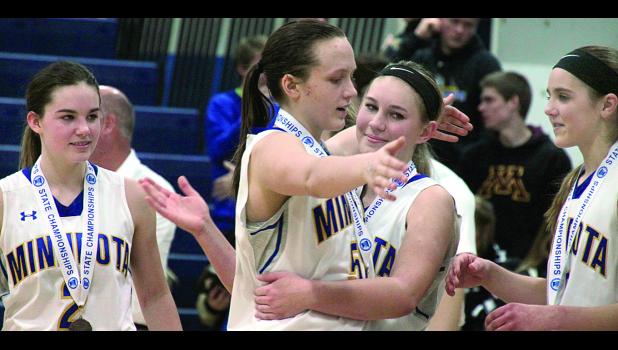 Lydia Sussner embraced Morgan Hennen after the third place win. Sussner and Abby Hennen were named to the All-Tournament Team. Sussner was named All-State before the start of the Tournament. Morgan Kockelman (left) and Natalee Rolbiecki looked on.
