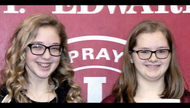 Staff Photo by Byron Higgin. St. Edward School Spelling Bee runner-up, Brooke Moorse, and Champion Ella Bot.