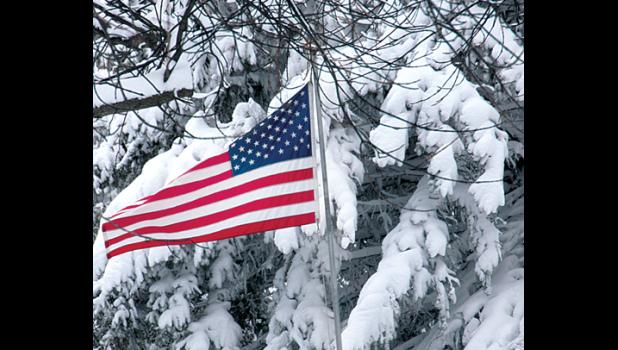 Staff Photo by Byron Higgin. An American flag blew in the wind after Friday night, Saturday morning’s snow turned Minneota back into a winter wonderland.