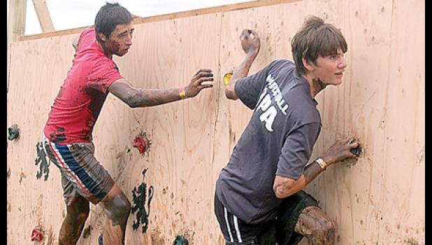 Staff photo by Scott Thoma. These two muddy, unidentified boys looked like Spiderman crawling a building.