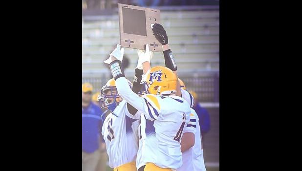 Photo for the Mascot by Brian Jeremiason. The Minneota Vikings volleyball and football teams hoist up their section championship trophies, respectively, after winning titles this past weekend in Marshall. The volleyball team beat RTR in the Section 3A championship on Saturday, while the football team won the Section 5A crown on Friday.