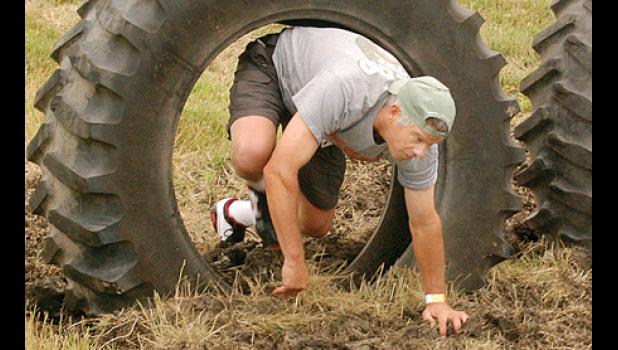 Staff photo by Scott Thoma. Fred Rabaey went low and through the tire part of the obstacle course.