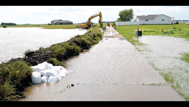 Special Photo. The walking path in Ghent had to be excavated to form a temporary berm in an attempt to protect the homes that are in the area. The unexpected water was similar to what happened to Ghent in 2010.