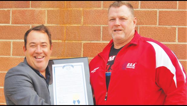Staff photo by Scott Thoma. Rep. Chris Swedzinski, left, congratulate Brad Gillingham on his recent induction into the USA Powerlifting Hall of Fame.