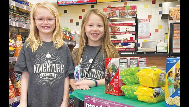 Contributed photo Addyson Pohlen, left, and Brisbyn Traen of Minneota Girl Scouts Troop 37814 remove their facial masks to pose for a photo next to their cookie stand at the C-Store. The girls sold over 60 boxes on Saturday. They will next be selling cookies on Saturday, Feb. 27 from 9 a.m. to noon at the Hy-Vee store in Marshall.