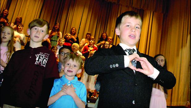 Staff Photo by Byron Higgin. The grand finale at the St. Edward School produced all the kids gathered to sing the song "Confidence".