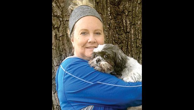 Special Photo. Like a foster mom, Caryn Hetland takes in dogs until they are adopted. Here Hetland is with Lucky Boy, a Shih Tzu foster dog who will soon be adopted by a family in Missouri.