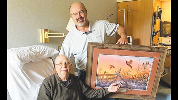 Contributed photo Dale Sterzinger, manager of the Lincoln Soil and Water Conservation District, presents a Pheasants Forever print to John Boulton, retired Lincoln Soil and Water Conservation District Supervisor, for his 56 years of service as a supervisor/board member.
