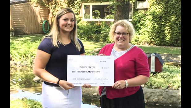 Special photo. Sydney Larson (left) receives a scholarship from the Care Providers of Minnesota Foundation from Jill Schewe, Care Providers of Minnesota Housing Director.