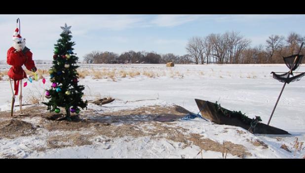 Staff Photo by Scott Thoma. "Slim the Pirate" prepares his island for Christmas.