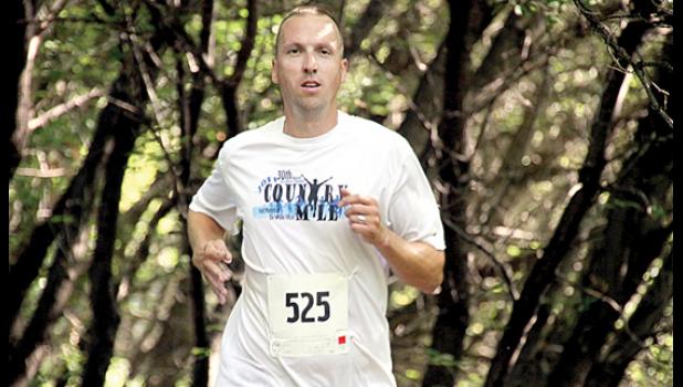 Staff Photo by Byron Higgin. For the fourth straight year, John Lorang of Woodbury returned to his hometown and won the Porter Harvest Festival 5K off-road race.