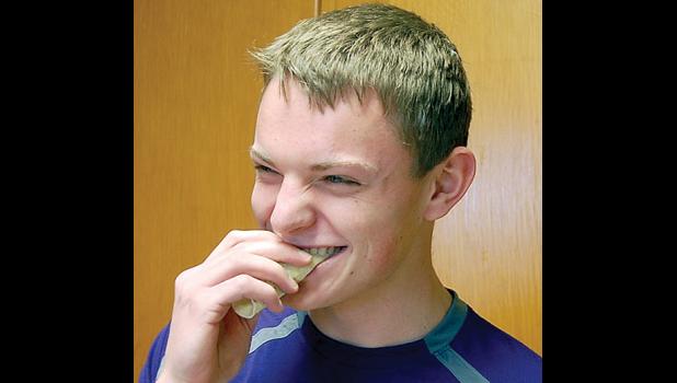 Staff photo by Scott Thoma. Jared Josephson took a bite out of lefse for the first time in his life. Although he enjoyed making them, he wasn’t a fan of the taste.