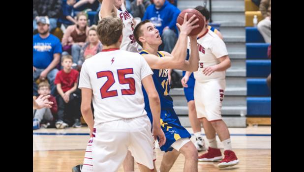 Photo for the Mascot by Brian Jeremiason. Joey Rybinski went up for a shot while being defended by Saints.