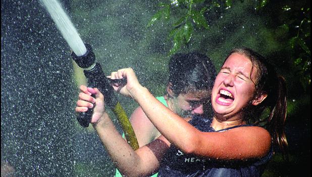 Staff Photo by Byron Higgin. Josie Frank laughed her way through the water fights.