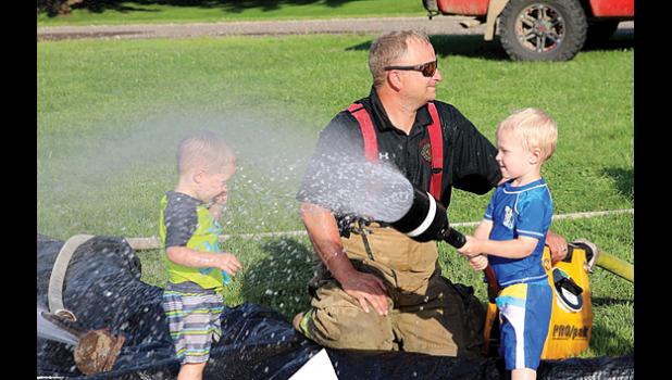Photo for The Mascot by Laura Buysse. Whether getting wet, walking the sobriety line, soaking each other or waving to the emergency helicopter, kids were having fun at National Night Out Tuesday in Minneota.