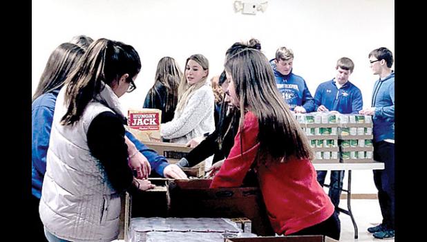 Special Photo. Minneota National Honor Society kids helped bag the goods collected through the Christmas Angels Program. They worked at the community center last Thursday.