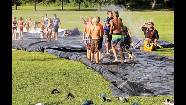 Photo for The Mascot by Laura Buysse. Whether getting wet, walking the sobriety line, soaking each other or waving to the emergency helicopter, kids were having fun at National Night Out Tuesday in Minneota.