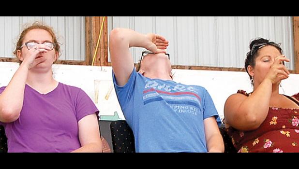 Staff Photo by Scott Thoma. Kimpe and others were told to take a swig of “joy juice” that will make them feel better.