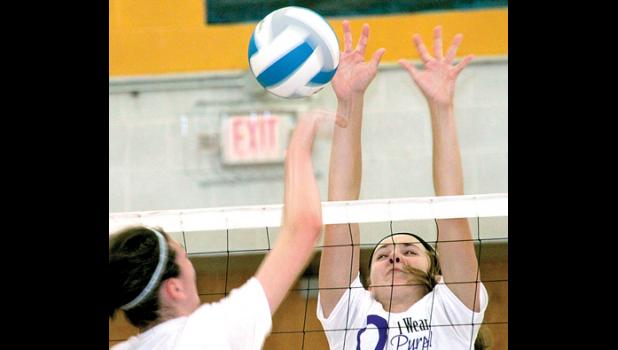 Staff Photo by Byron Higgin. Natalie Rolbiecki, is counted on for blocking, as she did in the scrimmage last week. She will also deliver a kill to the other side when necessary.