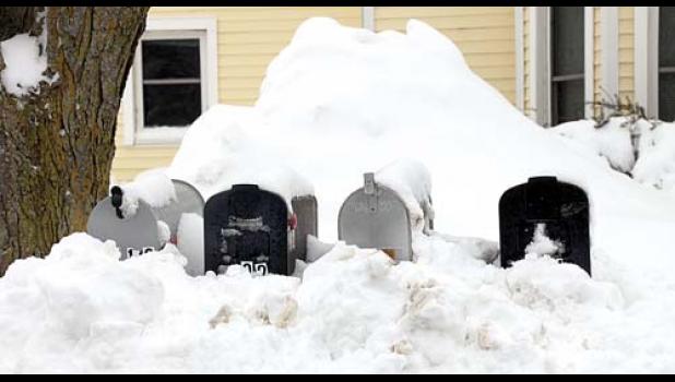 Staff Photo by Byron Higgin. Snow was piled up all over and after the plows came through it couldn’t be easy for the mailman to reach the boxes on Madison Street.