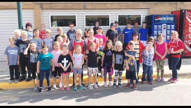 Staff Photo by Cecilia Rabaey. St. Edward students, staff and parents participated in the annual Marathon on Wednesday, October 9. They walked around Minneota singing the school song and the pledge song.