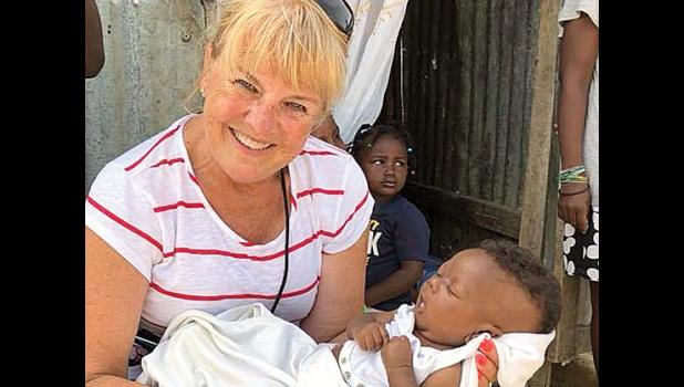 Special photo. Mary Maher holding a Haitian baby.