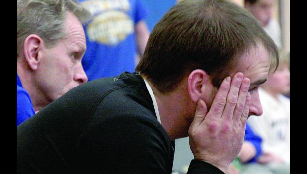 Staff Photo by Byron Higgin Assistant Coach Matt Buysse, with head Coach Joel Skillings in the background, watched as Minneota's dream of getting the wrestling team back in state went up in smoke Saturday afternoon.