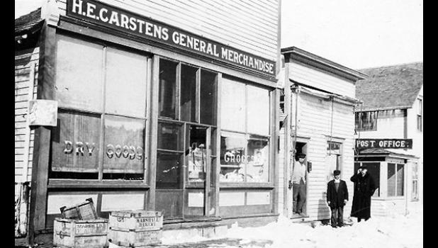 Special photo. This photo of Taunton businesses was taken in December of 1917 and shows the H.E. Carstens General Merchandise store, another unidentified business and the post office.