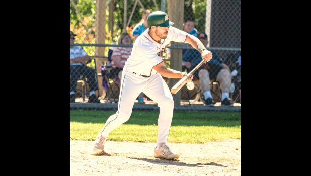 Mascot photo by Brian Jeremiason Tyson Sonnenburg lays down a bunt in Game 1 against Dumont on Saturday.