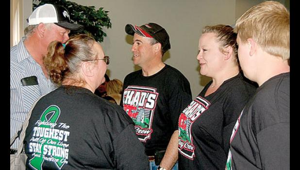 Staff photo by Scott Thoma. Chad, his wife Stacie and stepson Ty greet supporters at the benefit in his honor Sunday at the Cottonwood Community Center.