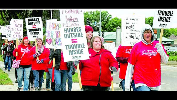 Special Photo Nurse walk and hold picket signs.