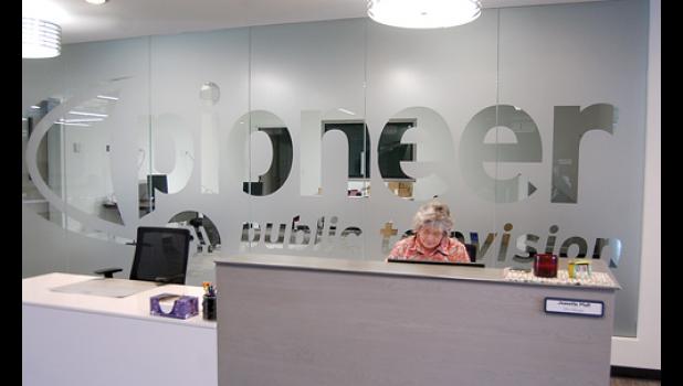Staff photo by Scott Thoma. Just inside the man door of the new facility in Granite Falls is the main lobby with the Pioneer name etched on a glass wall behind Office Manager Jeannette Pfaff.