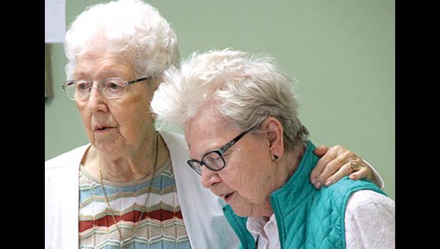 Staff photo by Byron Higgin. Residents Rita VanDorpe and Ruth Anderson joined in the singing together.