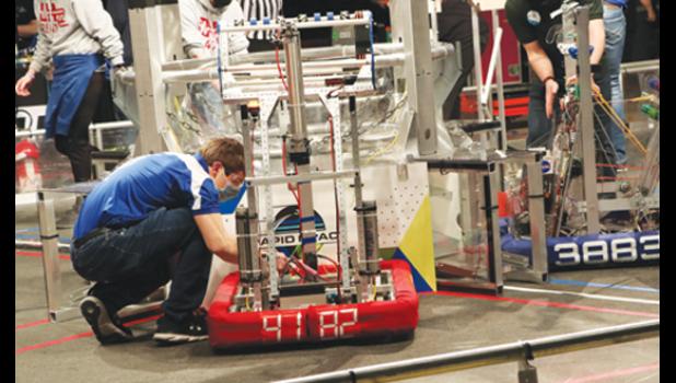 Contributed photo Technician Drew Lipinski positions the robot before the match.