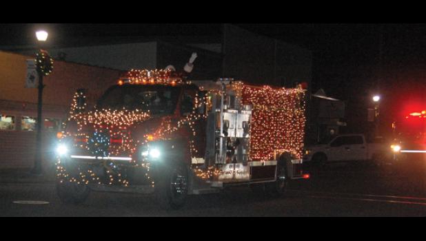 Mascot photo by Scott Thoma The Minneota fire trucks paraded through town Friday night with Santa Claus aboard one of the decorated trucks. Santa Claus waved and shouted "Merry Christmas" to the many children, parents and grandparents standing on the sidewalks.