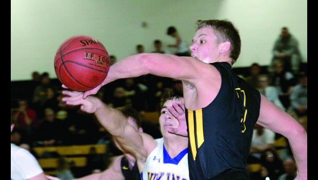 Staff Photo by Byron Higgin. Isaac Hennen had the ball slapped away by Colton Husby of Dawson-Boyd.