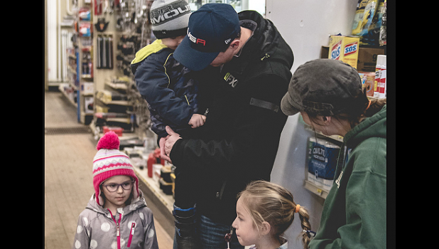 Photo for the Mascot by Brian Jeremiason. Devin Pohlen and his family purchased an order of cookies from scout Jules Gossen and her mother Shannon at Gislason’s Hardware in Minneota on Saturday.
