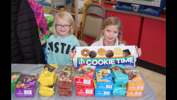 Photo by Scott Thoma. Addyson Pohlen, left, and Violet Vlaminck of Minneota Girl Scouts Troop #37814 were all smiles while selling Girl Scout Cookies at AgPlus in Minneota on Saturday.